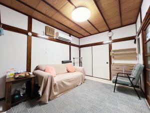 a bedroom with a bed and a desk and a chair at Tokyo Nukumori Lodge in Tokyo