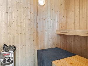 a room with a stove in a wooden wall at 5 star holiday home in Grenaa in Grenå