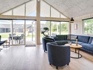a living room with a couch and chairs and a table at 5 star holiday home in Grenaa in Grenå +31 photos