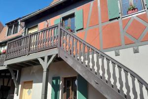 a house with a staircase on the side of it at Apartment in Dambach near Vineyards in Dambach-la-Ville