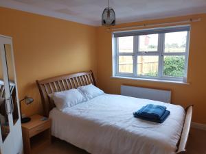 a bedroom with a bed with a blue towel on it at Deja Blue in Sutton on Sea