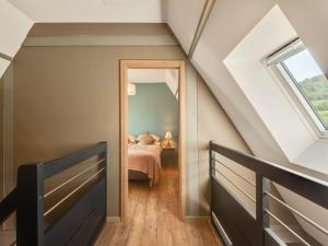 a attic bedroom with a bed and a window at Apartment in Dambach near Vineyards in Dambach-la-Ville