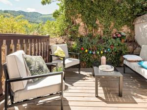 a deck with chairs and a table and a couch at Apartment in Dambach near Vineyards in Dambach-la-Ville