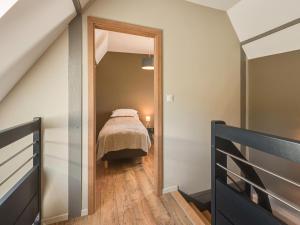 a bedroom with a bed and a mirror at Apartment in Dambach near Vineyards in Dambach-la-Ville