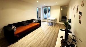a living room with a couch and a table at Eugène - Elégance & Confort in Reims