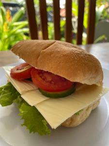a sandwich with tomatoes and cheese on a plate at Green Merta in Padangbai