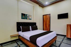 a bedroom with a large bed in a room at Hotel O Royal Inn in Mumbai