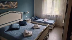 a bedroom with two beds with towels on them at La Casa nel Parco in Moncalieri