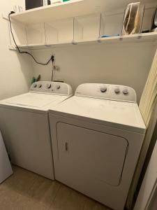 a small laundry room with a washer and dryer at West Tawakoni Lake House in West Tawakoni +25 photos