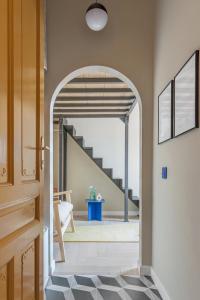 an archway leading into a hallway with a staircase at Adorján Apartments - Sunset Studio in Oradea +11 photos