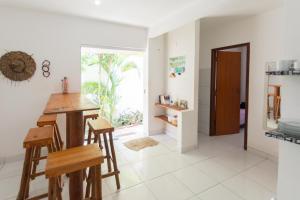 a kitchen with a table and chairs in a room at Pipa Guest House in Pipa +18 photos