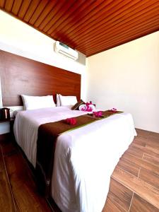 a bedroom with a large bed with flowers on it at Valley Palm Seaview in Guraidhoo