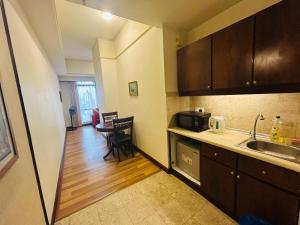 a small kitchen with a sink and a table at KL Better Apartment at Times Square KL in Kuala Lumpur