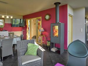 a living room with a fireplace and a dining room at Ovifat Sauna Escape, Waimes in Ovifat +32 photos