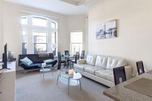 a living room with a couch and a table at Heaven on Washington Fully Furnished Apartments in Washington, D.C.