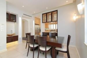 a kitchen and dining room with a table and chairs at Bright, Spacious, & Homey Central Rechavia Residence in Jerusalem