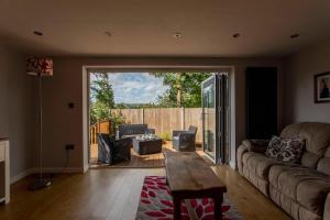 a living room with a couch and a table at Abbey Rectory - with private parking in Bath