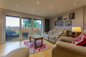 a living room with a couch and a table at Abbey Rectory - with private parking in Bath