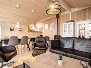 a living room with a couch and a table at 5 star holiday home in Højslev in Sundstrup
