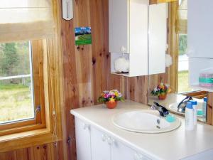 a bathroom with a sink and a mirror at 6 person holiday home in lyngdal-By Traum in Lyngdal +11 photos