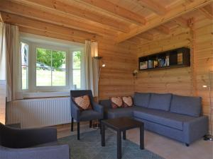 a living room with a blue couch and chairs at Naturrefugium bei Willingen in Medebach