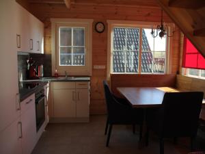a kitchen with a table and chairs in a room at Naturrefugium bei Willingen in Medebach
