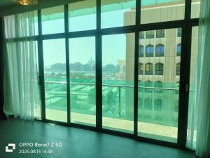a view from a large window in a building at City Point Hotel in Manama