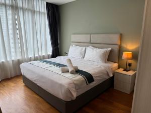 a bedroom with a bed with a towel on it at Vortex Suites klcc City Road By Classic Crest in Kuala Lumpur