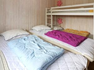 two bunk beds sitting next to each other in a room at 4 star holiday home in Storvorde in Storvorde