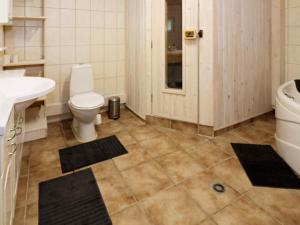 a bathroom with a toilet and a sink and a tub at 4 star holiday home in Storvorde in Storvorde +32 photos