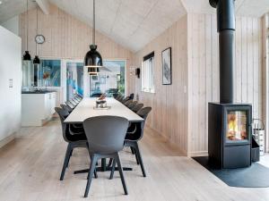 a dining room with a table and a fireplace at 5 star holiday home in Ringkøbing in Ringkøbing +44 photos