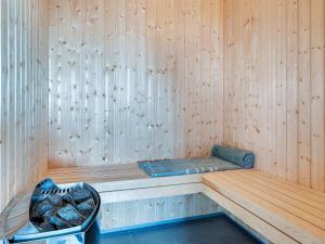 a sauna with a bench in a wooden wall at 5 star holiday home in Ringkøbing in Ringkøbing