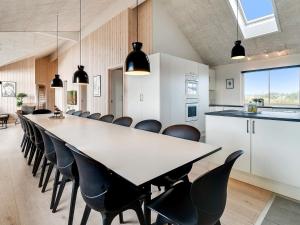 a large dining room with a long table and chairs at 18 person holiday home in Ringkøbing in Ringkøbing