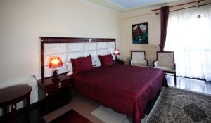 Postel nebo postele na pokoji v ubytování Orchidea Hotel