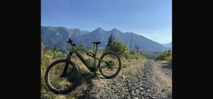 a bike parked on the side of a dirt road at Sun&Ski Maciejówka Domki Białka Tatrzańska in Białka Tatrzańska