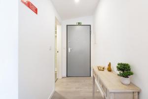 a hallway with a door in a white room at GuestReady - Modern Aveiro nook in Aveiro