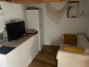 a living room with a couch and a flat screen tv at Casa rural Lo Regolfo in La Codoñera