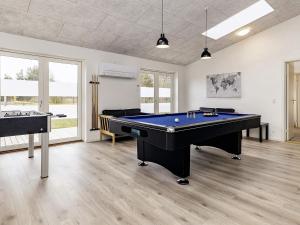 a large room with a pool table and two tables at 5 star holiday home in Væggerløse in Bøtø By
