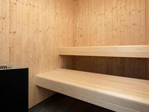 a room with wooden shelves in a sauna at 5 star holiday home in Væggerløse in Bøtø By