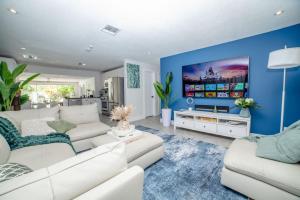 a living room with white couches and a blue wall at Chic MangoTree villa Private Heated Pool in Fort Lauderdale