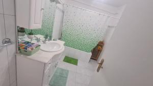 a white bathroom with a sink and a shower at Casa Santo António in Água de Alto +22 photos