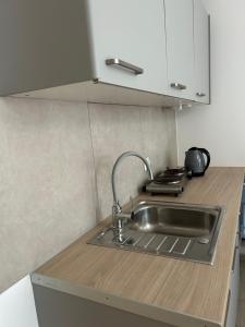 a kitchen with a sink and a counter top at Lawendlove in Kraków