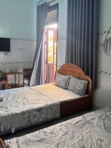 una camera con letto e tavolo con televisore di Hotel Hải Hà a Phan Thiet Altre 23 foto