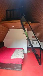 a bunk bed in a room with a red floor at Vattavada Jungle Resort in Munnar