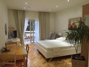 a bedroom with a bed and a table and a desk at Apartments Jani in Hvar