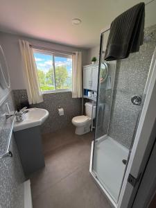 a bathroom with a shower and a toilet and a sink at Hostellerie du Suroît in Beauharnois +27 photos