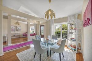 a dining room with a table and white chairs at Family Retreat - Sleeps 10 - Pool - Near Beach in Port Charlotte