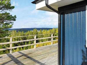 a deck with a view of the woods at 8 person holiday home in Henån-By Traum in Henån