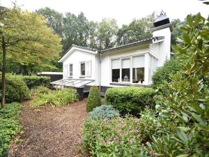 a white house with a garden in front of it at Holiday Home in Holten near Holterberg in Holten +29 photos