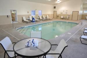 a large pool with a table and chairs and a tableasteryasteryasteryasteryastery at Wingate by Wyndham Ashland in Ashland